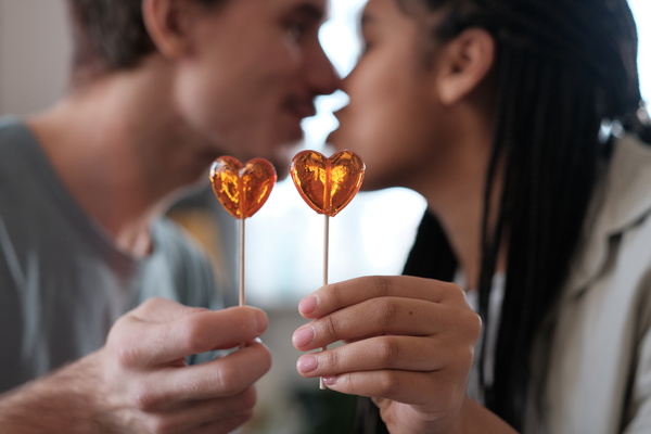 Heart-Shaped Lolipops on Happy Couple Background